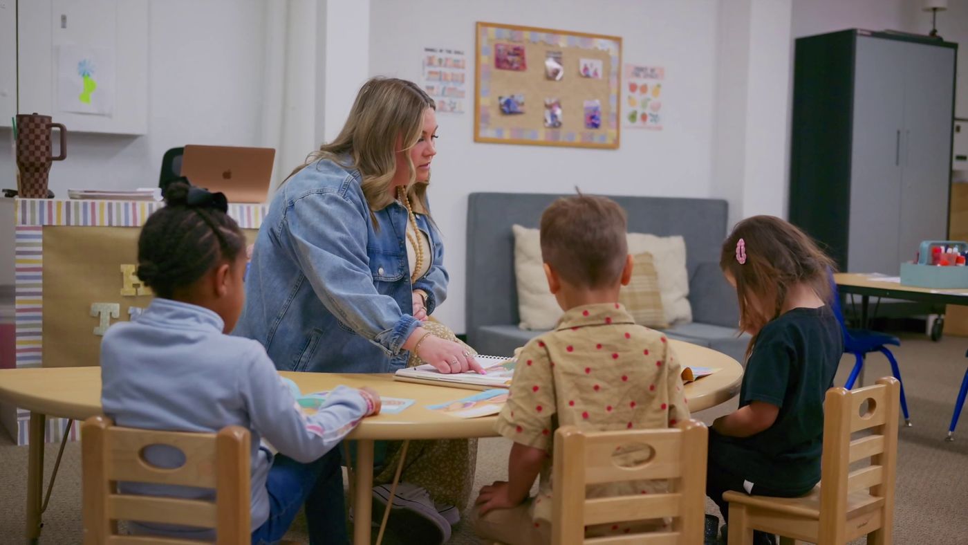 Mrs. Heuslein working with TK students at a classroom table
